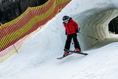 Low angle view of man skiing on snow covered mountain