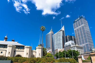 Low angle view of modern buildings against blue sky