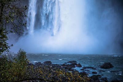 Scenic view of waterfall against sky