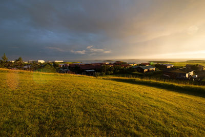 Scenic view of field against cloudy sky