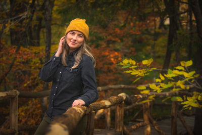 Portrait of young woman standing in forest