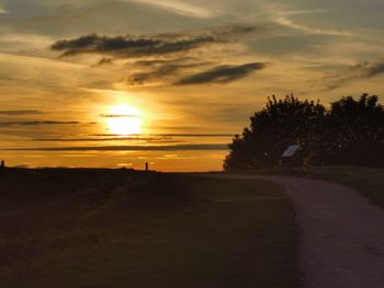 Scenic view of silhouette landscape against sky at sunset