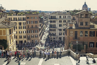 People on street in city against sky