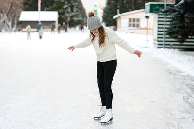 Full length of woman standing on snow