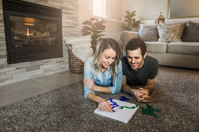 Woman sitting on sofa at home