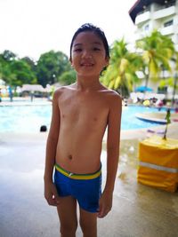 Portrait of shirtless boy standing at beach