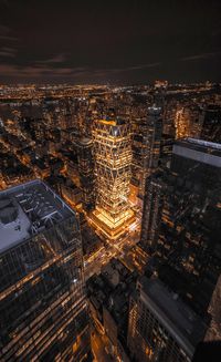 High angle view of illuminated cityscape against sky at night