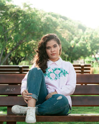Portrait of girl sitting on bench