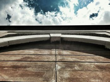 Low angle view of building against cloudy sky