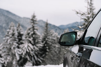 View of car on snow covered mountain during winter