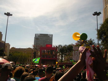 People on street against sky in city