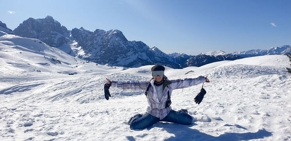 Full length of person on snowcapped mountains against sky