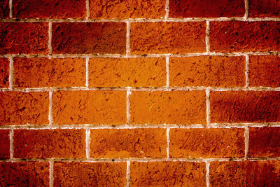 The wall made from red solid bricks