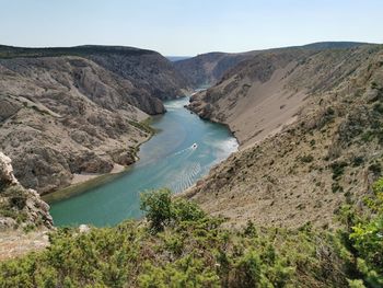 High angle view of river and mountains against sky