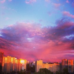 Cityscape against cloudy sky