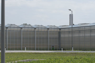 View of factory against cloudy sky