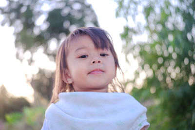 Portrait of girl standing on land during sunset