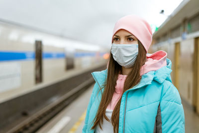 Portrait of young woman at railroad station