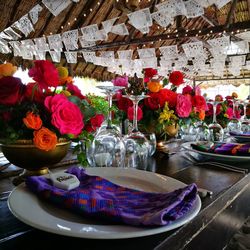 Multi colored flowers in glass on table