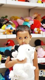 Portrait of cute girl with toy toys