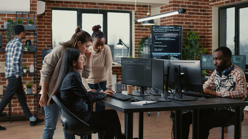 Colleagues working on computer in office