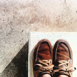 Low section of person standing on tiled floor