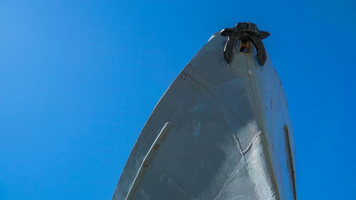 Low angle view of sailboat against clear blue sky