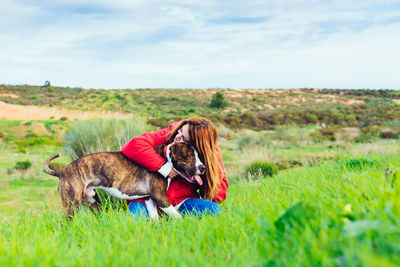 Woman and dog on field