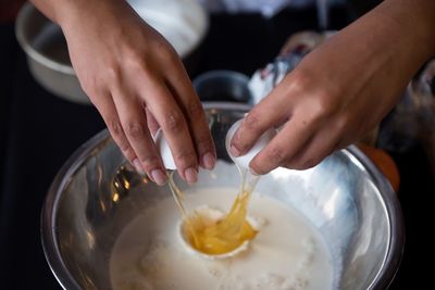 Midsection of woman preparing food in kitchen