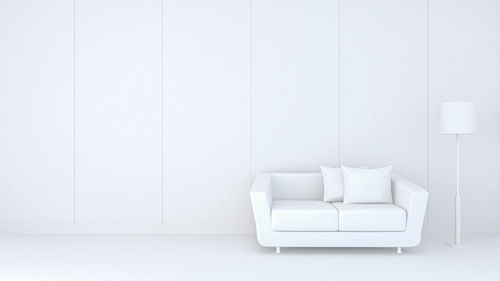 Empty chair against white wall at home