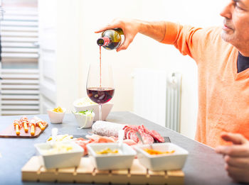 Midsection of man preparing food on table