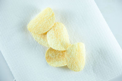 High angle view of potato chip on tissue paper