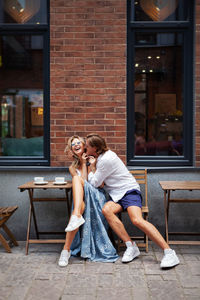 Couple kissing while sitting at cafe