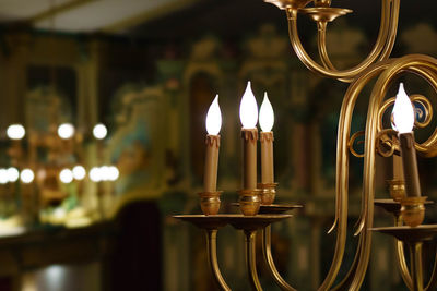 Close-up of illuminated candles in temple