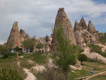 Low angle view of rock formation against cloudy sky