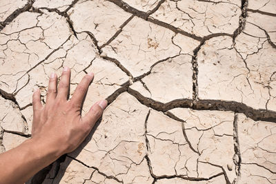 Close-up of human hand in desert