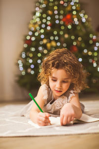 Boy sitting on table at home