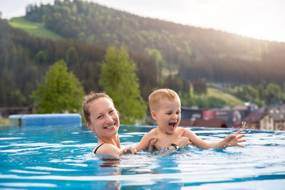 Portrait of boy swimming in pool