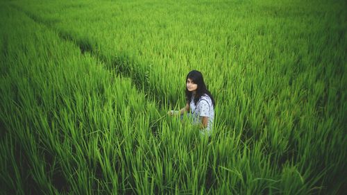 High angle view of woman sitting on field