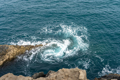 High angle view of rock formation in sea