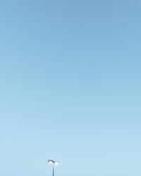 Low angle view of street light against clear blue sky