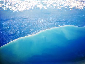 Aerial view of sea against blue sky