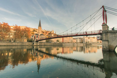 Bridge over river with buildings in background