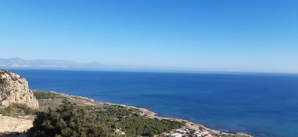 Scenic view of sea against clear blue sky