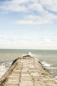 Scenic view of sea against cloudy sky