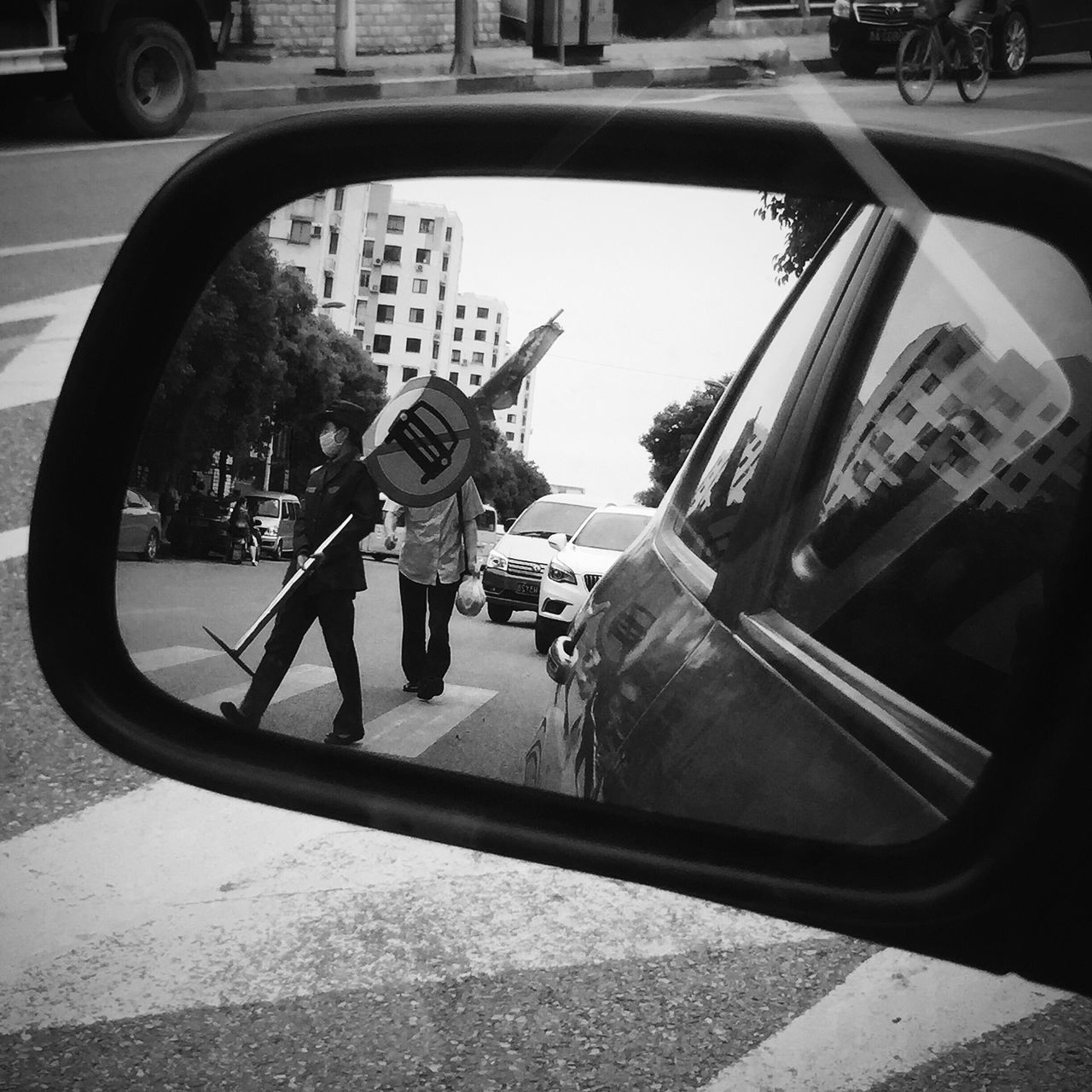 REFLECTION OF MAN ON CAR