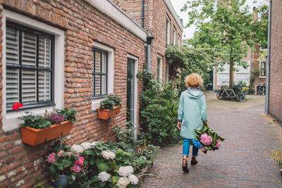 Rear view of woman walking on street