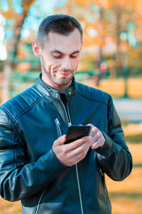 Mid adult man using mobile phone