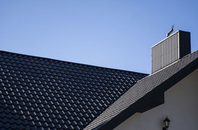 Low angle view of modern building against clear blue sky