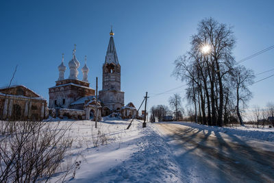 Panoramic view of trees and buildings against sky during winter